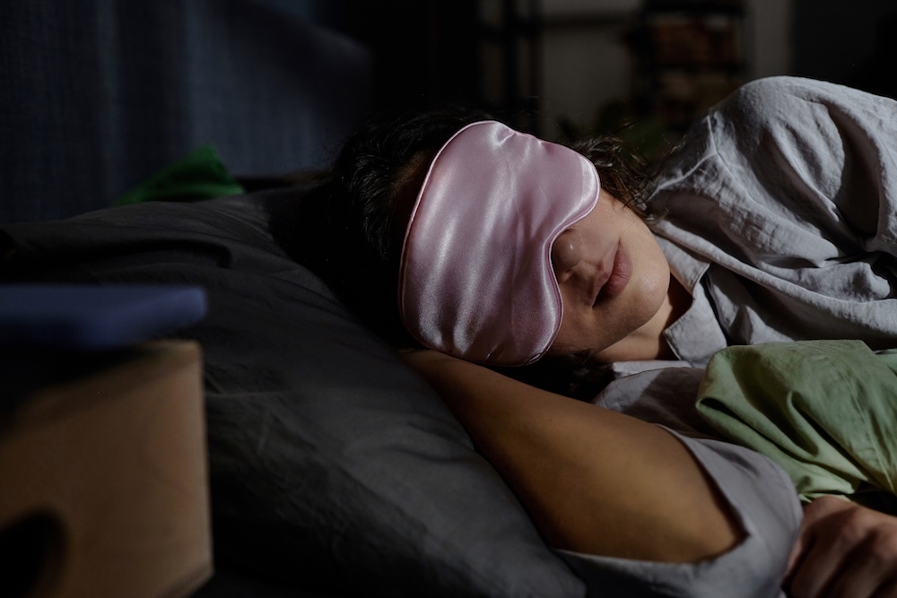 Woman sleeping with eye mask for better rest